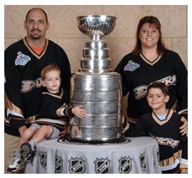 a photograph of the Posner family with the Stanley Cup